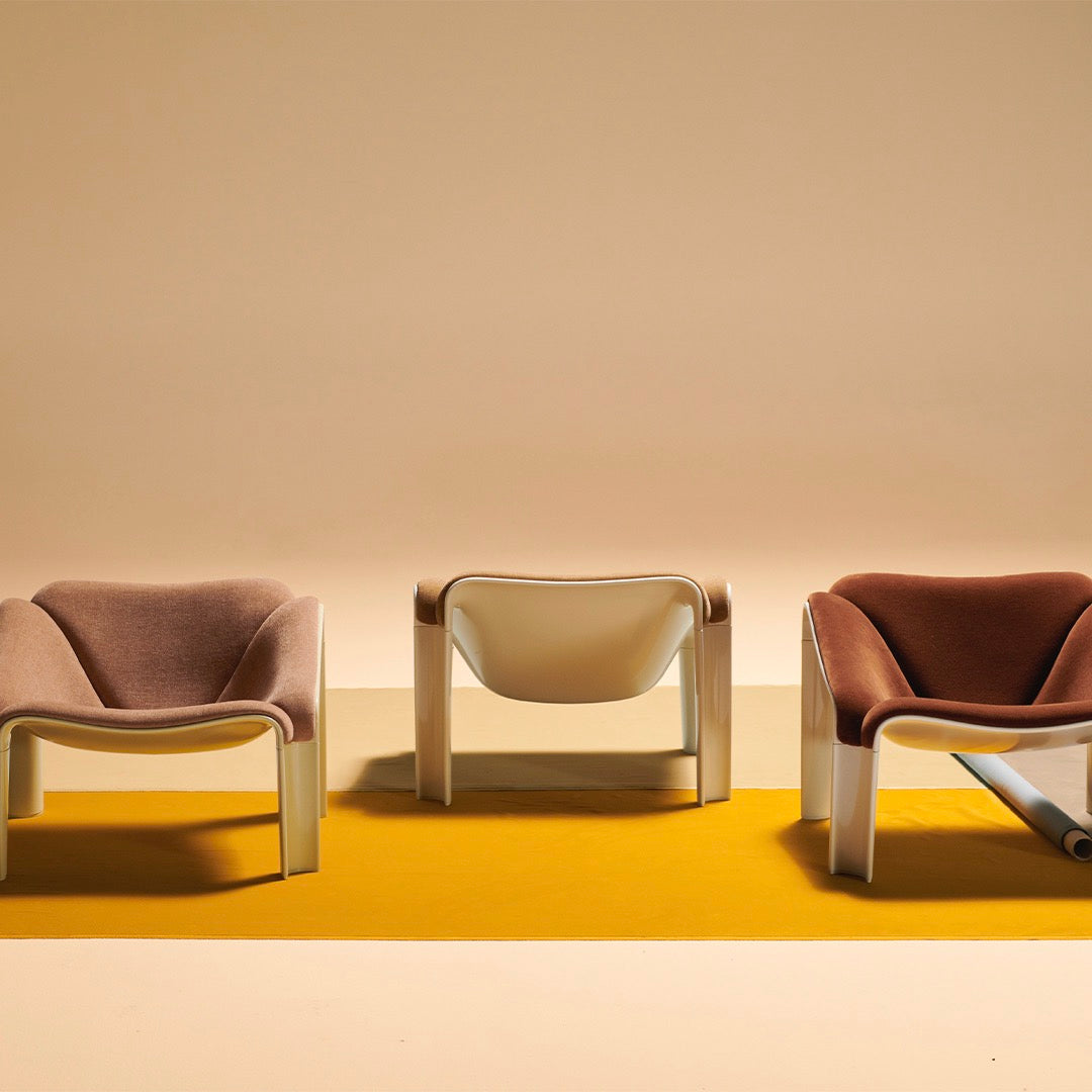 Stylish chairs in lavender, white, and blush, set against a vibrant yellow geometric backdrop. Perfect for modern decor.