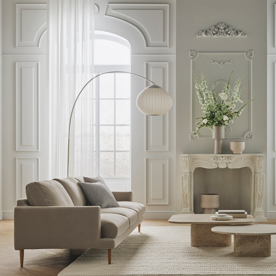 Beige sofa with light gray walls, elegant white curtains, and soft neutral decor, featuring subtle textures and patterns.