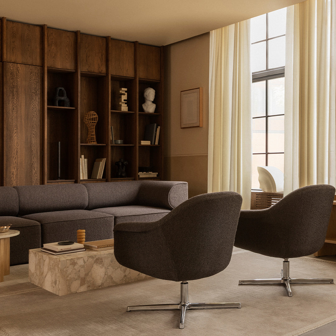 Modern living room with gray upholstery, warm wood tones, and neutral curtains, featuring a marble coffee table.