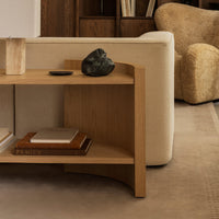 Wooden console table with a natural finish, featuring smooth lines and minimal geometric patterns against a beige backdrop.