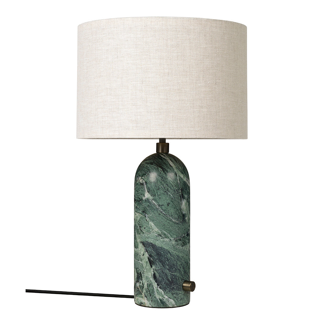 Green marble lamp base with swirling patterns and a cream-colored linen shade. Modern and elegant design.