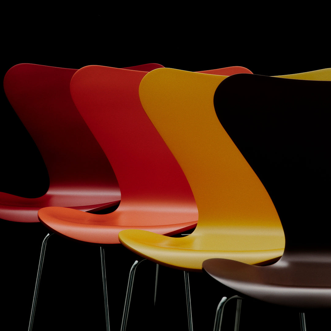 Colorful modern chairs in red, orange, yellow, and brown with sleek, curved designs against a black backdrop.