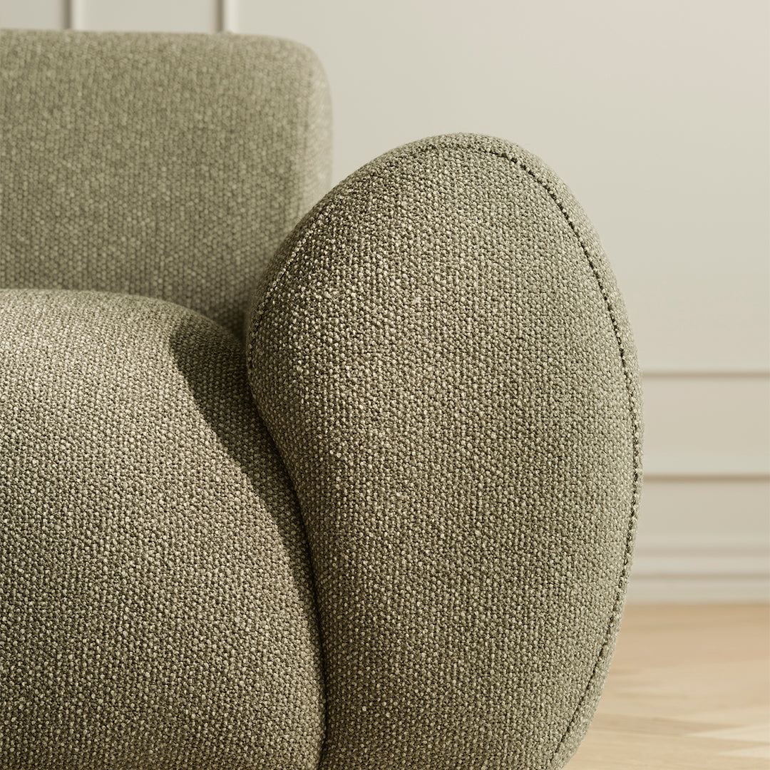 Textured olive green fabric upholstery with a soft, rounded armrest for a cozy, modern aesthetic.