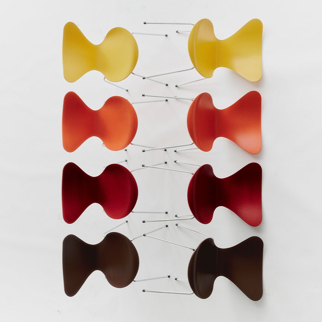 Colorful wall decor featuring a vibrant gradient of yellow, orange, red, and brown in playful, curved shapes.