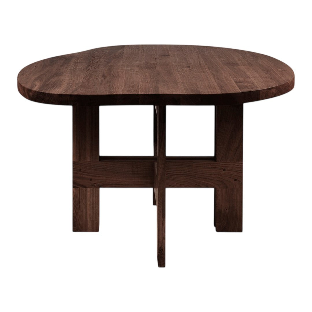 Brown oak dining table with a smooth, rounded top and a unique cross-legged base design.