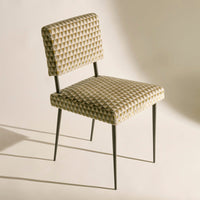 Checkered beige and olive pattern chair with a minimalist black metal frame. Perfect for stylish dining spaces.