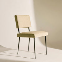 Beige upholstered chair with a minimalist design and sleek black metal legs, perfect for modern decor.
