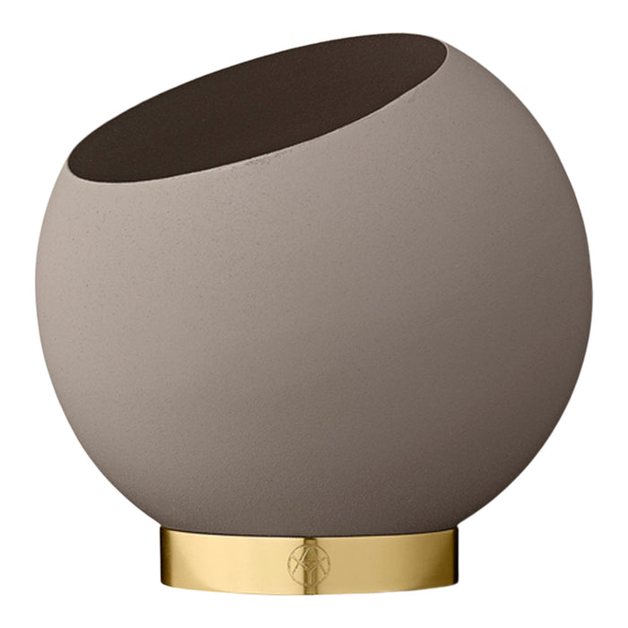 Round ceramic vase in soft taupe with a dark brown rim and a sleek gold base. Modern and stylish design.