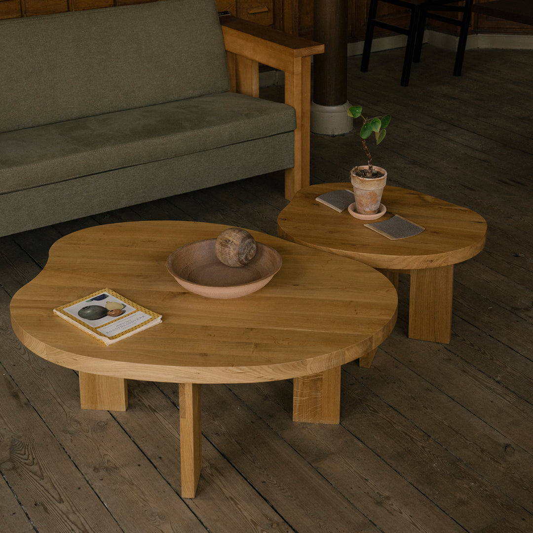 Natural wood coffee tables with organic shapes, featuring a light brown finish and minimalist design.