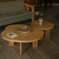 Natural wood coffee tables with organic shapes, featuring a light brown finish and minimalist design.