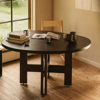 Brown round table with a minimalist design, featuring a dark finish and subtle wood grain patterns.
