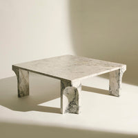 Gray marble coffee table with a sleek, minimalist design and distinctive veining patterns on the surface and legs.