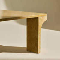 Golden beige table with smooth, minimalist design and subtle marbling, perfect for modern decor.
