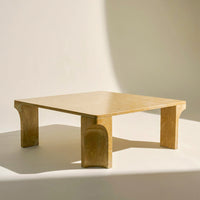 Modern square coffee table in soft beige with smooth, rounded edges and a minimalist design. Perfect for contemporary decor.