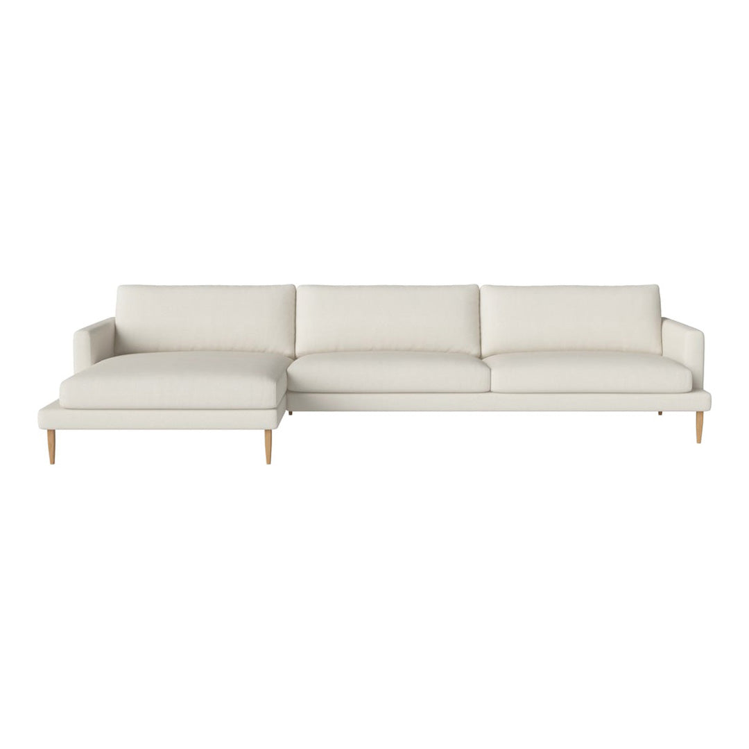 Light beige sectional sofa with a smooth texture and modern minimalist design, featuring soft cushions and wooden legs.