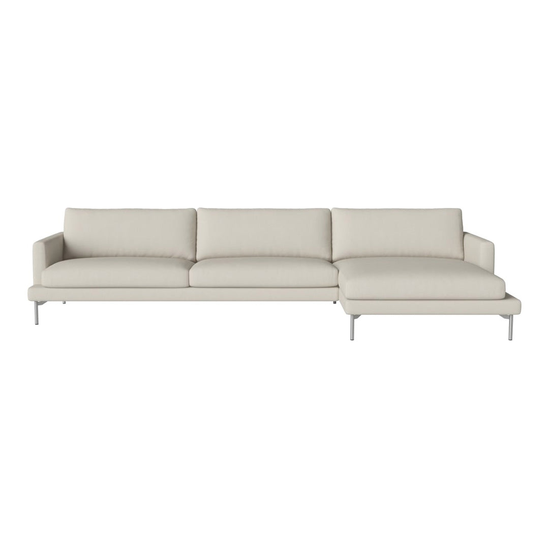Light beige sectional sofa with smooth fabric and minimalist design, featuring plush cushions and sleek silver legs.
