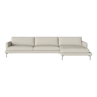 Light beige sectional sofa with smooth fabric and minimalist design, featuring plush cushions and sleek silver legs.