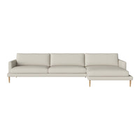 Light beige sectional sofa with smooth fabric and minimalist design, featuring clean lines and natural wood legs.