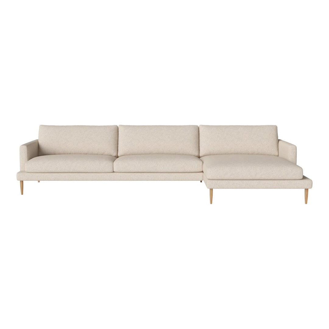 Light beige sectional sofa with smooth fabric and wooden legs, featuring a minimalistic design and no visible patterns.