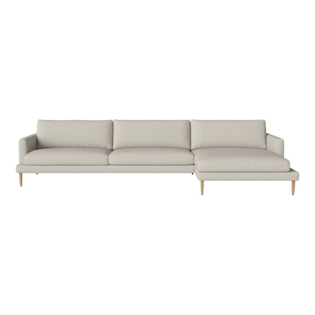 Light beige sectional sofa with a modern design and smooth upholstery, featuring wooden legs for an elegant touch.