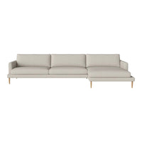 Light beige sectional sofa with a modern design and smooth upholstery, featuring wooden legs for an elegant touch.