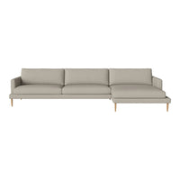 Light gray sectional sofa with a modern design and smooth fabric, featuring simple lines and wooden legs.