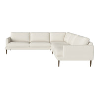 L-shaped sectional sofa in soft cream fabric with clean lines and wooden legs, perfect for modern living rooms.