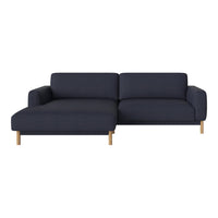 Navy blue sectional sofa with a modern design and light wood legs, featuring a smooth, textured fabric.