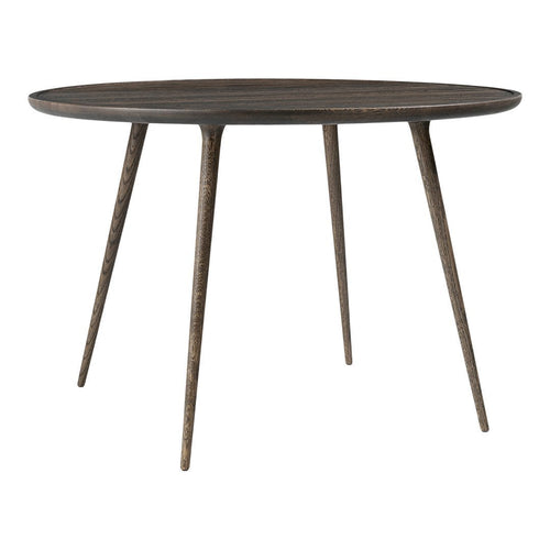 Round dark wood table with minimalist design and natural grain pattern. Sleek, tapered legs add an elegant touch.