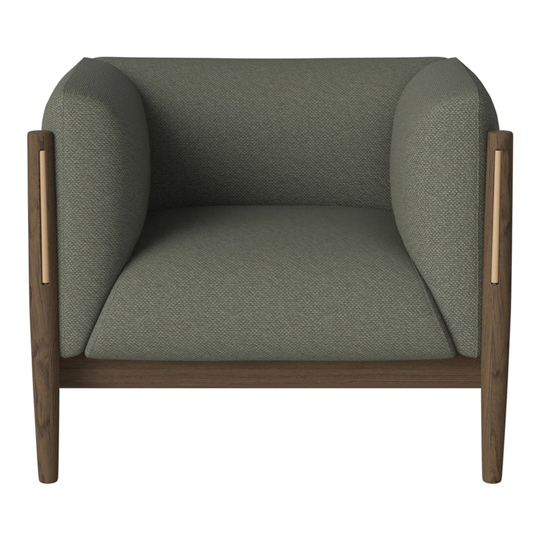 Green upholstered armchair with smooth, rounded cushions and wooden accents. Modern design with a minimalist aesthetic.