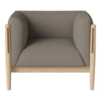 Gray upholstered armchair with rounded arms and natural wood accents. Minimalist design with a neutral color palette.