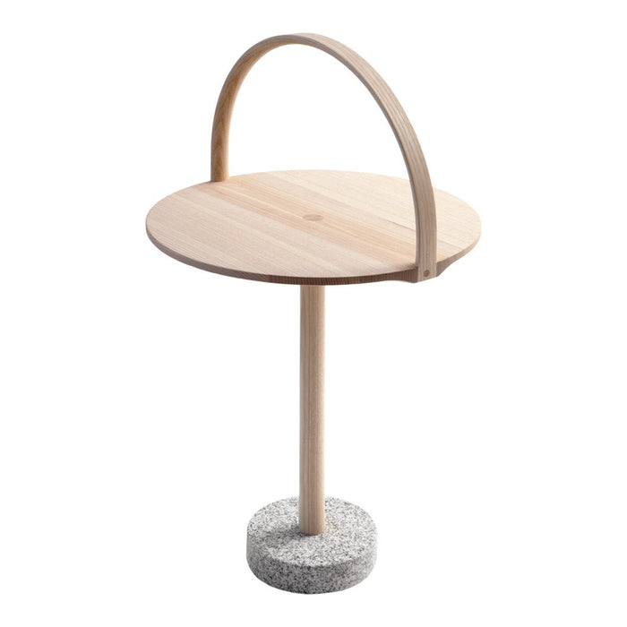 Natural wood table with a round light wood top and a textured gray concrete base, featuring a curved wooden handle.