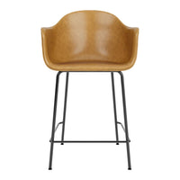 Tan upholstered bar stool with a smooth, curved seat and contrasting black metal legs. Modern and stylish design.