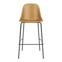 Tall bar stool with a sleek caramel-colored seat and contrasting black metal frame. Stylish and modern design.