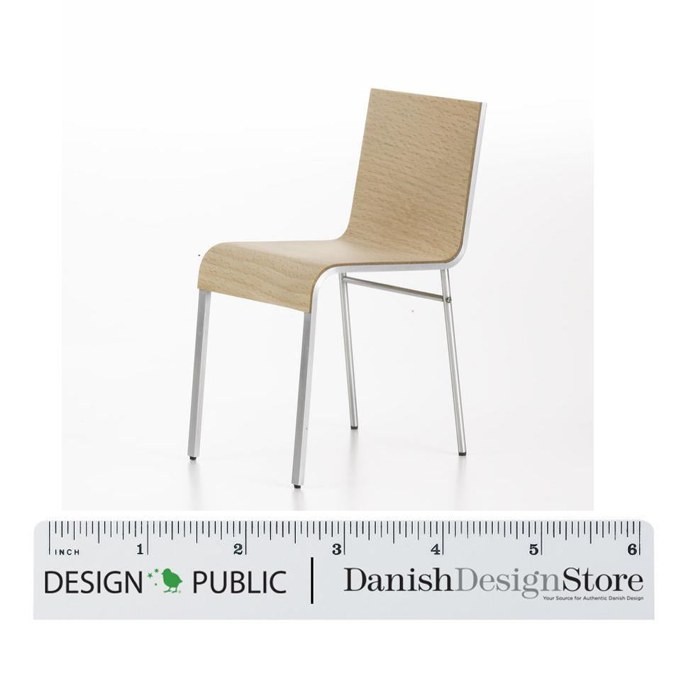 Light beige chair with a textured wood grain pattern and sleek silver metal legs, perfect for modern decor.