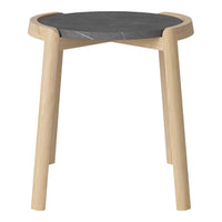 Natural wood legs with a sleek black stone top, featuring a minimalist design and smooth finishes.