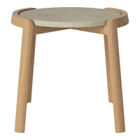 Light wood legs support a round, smooth gray concrete top, showcasing a modern minimalist design.