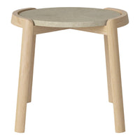 Light wood legs with a round, gray concrete top, featuring a smooth surface and minimalist design.