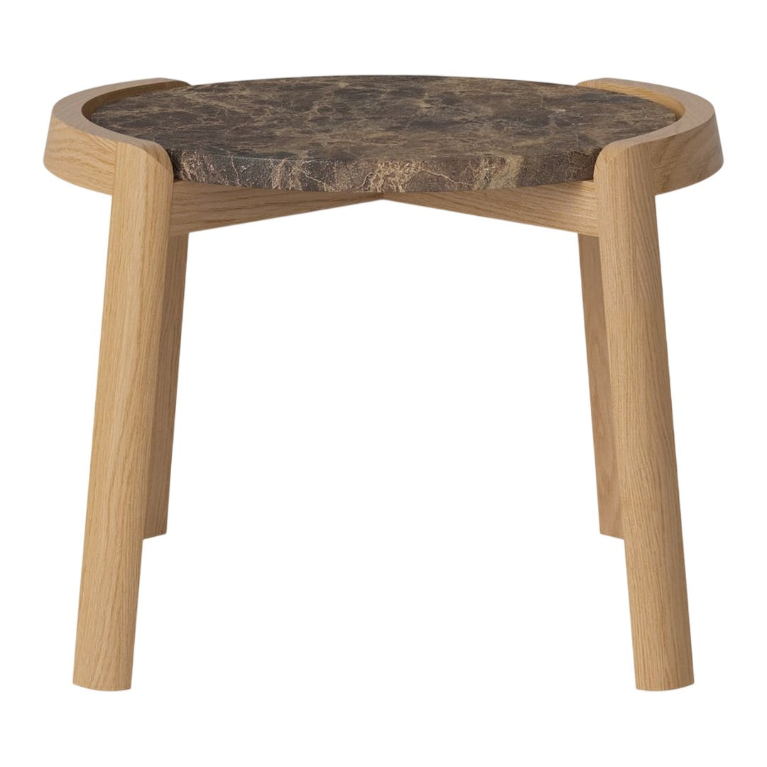 Natural wood stool with a round top featuring a dark, textured surface and light-toned wooden legs.