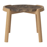 Natural wood stool with a round top featuring a dark, textured surface and light-toned wooden legs.