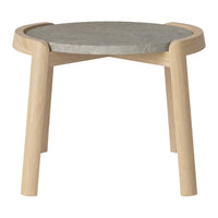Light wood legs with a round, gray stone top; minimalistic design with a warm, natural aesthetic.