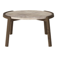 Round coffee table with a textured beige marble top and dark wood legs, featuring a minimalist design.