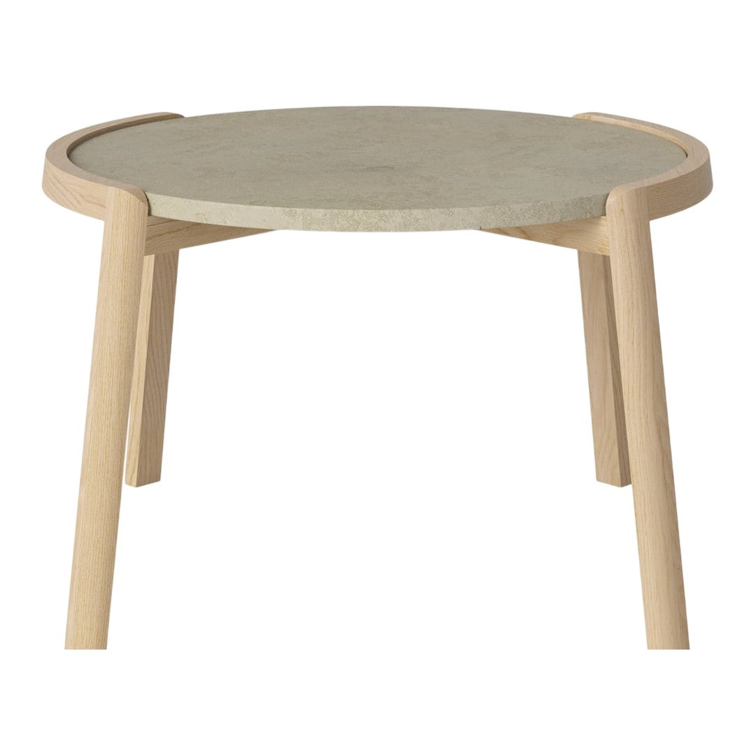 Light wood legs support a round, textured grey tabletop with smooth, minimalist design and subtle curves.