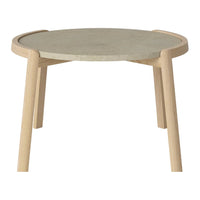 Light wood legs support a round, textured grey tabletop with smooth, minimalist design and subtle curves.