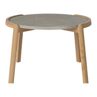 Round table with a gray patterned top and light wooden legs, showcasing a modern, minimalist design.