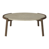 Round coffee table with a smooth beige top and contrasting dark wood legs, featuring a minimalist design.