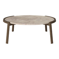 Round coffee table with a textured light stone surface and dark wooden legs, showcasing a modern minimalistic design.