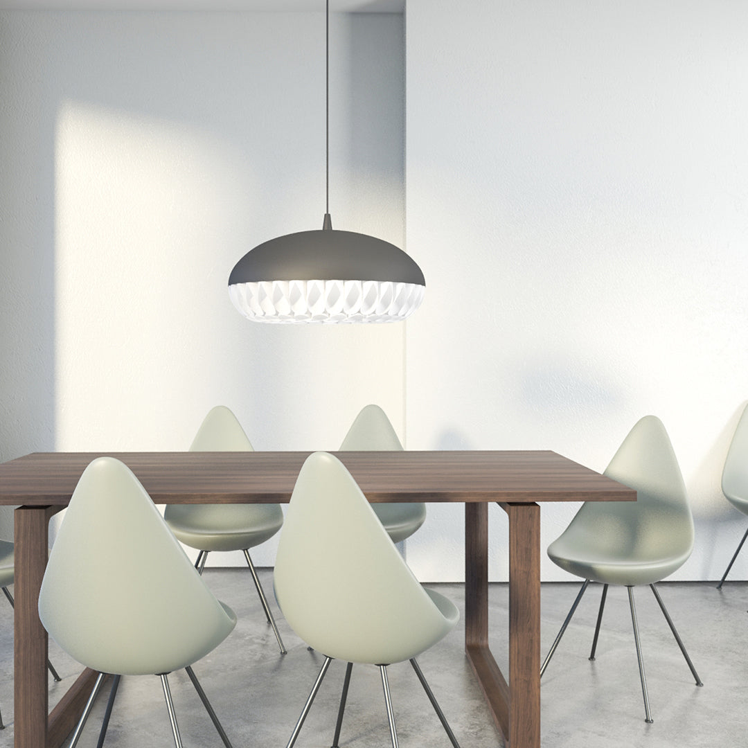Sleek gray pendant light above a wooden table and soft green chairs, enhancing modern dining aesthetics.