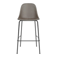 Gray upholstered barstool with a smooth finish and sleek black metal legs, perfect for modern decor.