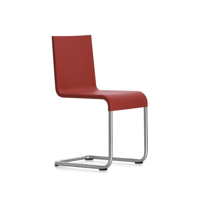 Red minimalist chair with a sleek design and smooth finish, complemented by a sturdy silver frame.